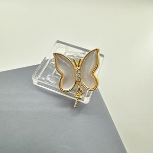 Macro shot of 18k gold plated butterfly pendant with iridescent shell wings and zircons