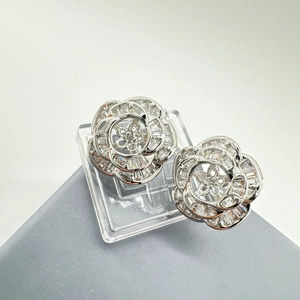 Macro shot of 925 silver camellia earring with micro-set shell and cubic zirconia stones