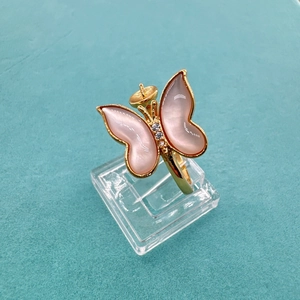 Detail of gold butterfly ring base with iridescent shell inlay and zircon accents