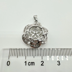 Macro view of 925 silver camellia flower pendant base measuring 2.5cm with zircons