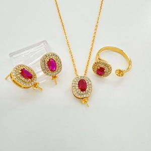 Luxurious gold-plated jewelry set with ruby-red oval stones and pavé zircon accents