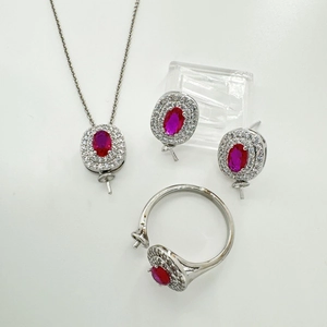 Detailed view of silver oval red gemstone jewelry set with necklace earrings and ring