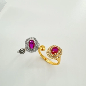 Detail of oval red zircon rings in gold and silver finish with pavé micro-inlays