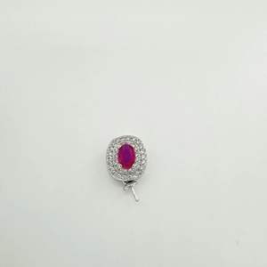 Macro view of a 925 silver pendant with red oval gemstone and double zircon halo