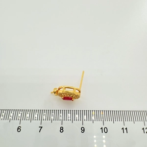Detail view of gold-plated S925 silver earring with red gemstone and pavé zircon stones