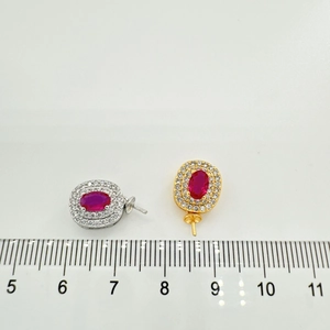 Macro view of gold and silver plated oval red stone earring settings with micro-pave crystals