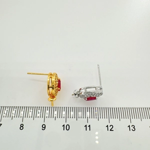 Detailed macro view of ruby style earrings with gold and silver finish and scale reference
