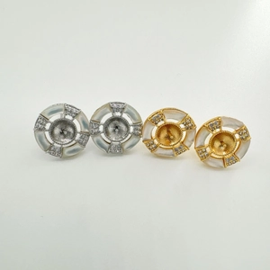 Macro view of round shell earring bases in gold and silver plating with zircon accents