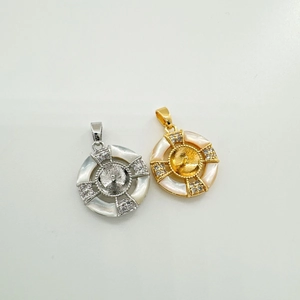 Detail of round shell pendants with pearl settings in gold and silver finishes