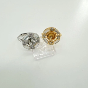 Macro view of gold and silver adjustable ring bases with white shell inlay for DIY jewelry