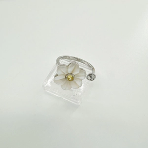 Detailed macro view of S925 silver floral ring with white petals and yellow gemstone