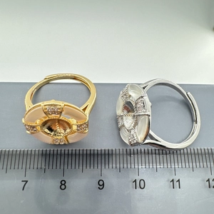 Detailed view of 2cm shell-inlaid ring showing adjustable open band size measurement