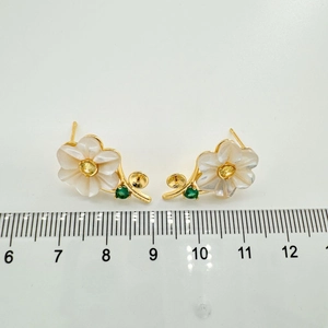 Macro shot of 2cm floral stud earring with shell petals and size scale measurement