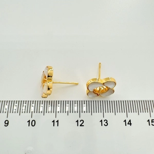 Detailed view of 1.2cm gold-plated flower earrings with white shell inlay and ruler