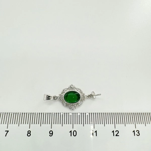 Detailed view of vintage emerald zircon pendant measuring 2.5cm with silver pearl accents