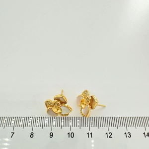 Macro view of flower stud earring with zircons and shell petals measuring 1.5cm width