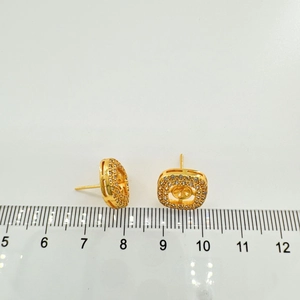 Macro shot of 10mm gold square stud earrings with zircons and s925 silver needles