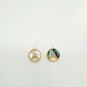 Macro shot of 18K gold-plated shell butterfly pendants with inset zircon detail