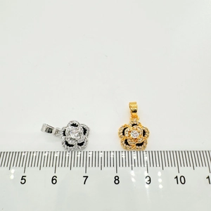 Detailed macro view of 18K gold-plated flower charms with scale measurement