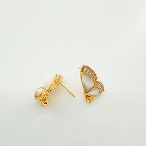 Detail of 18K gold-plated butterfly stud earrings with white shell inlay and zircon accents