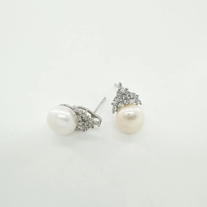 Close-up of crown-shaped silver earring settings with white pearls and small crystals