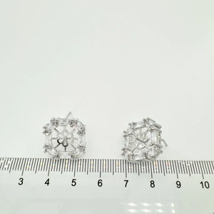 Macro view of 18K gold plated square earring settings with zircon accents and scale