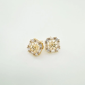 Macro detail of 18K gold plated geometric stud earring with sparkling zircon inlay