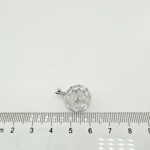 Macro view of a 1.5cm geometric s925 silver pendant with white cubic zirconia accents