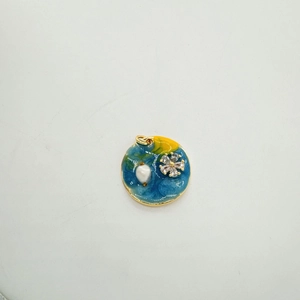 Detail of star-themed enamel pendant with moon and pearl for DIY jewelry making
