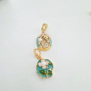 Macro shot of Monet oil painting style flower pendants with enamel and freshwater pearls