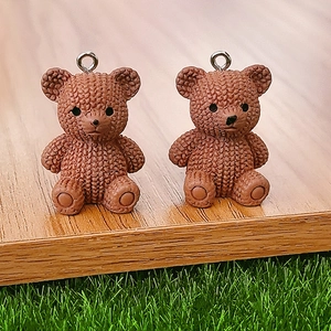 Pair of brown resin bear charms with knitted texture and silver metal rings