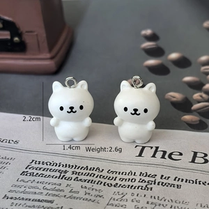 Detail view of white resin bear charms showing dimensions of 2.2cm by 1.4cm for jewelry DIY