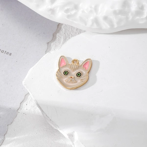 Cute beige cat head alloy pendant with green eyes for DIY jewelry and keychains