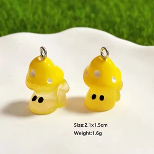 Detailed view of yellow resin mushroom pendants with 2.1x1.5cm size markings