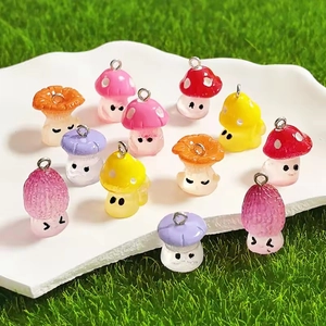 Luminous resin mushroom pendants in mixed colors on a white plate with green grass background