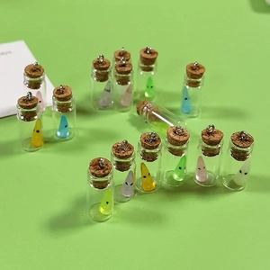 Miniature glass jars with resin ghosts and cork stoppers for DIY jewelry making