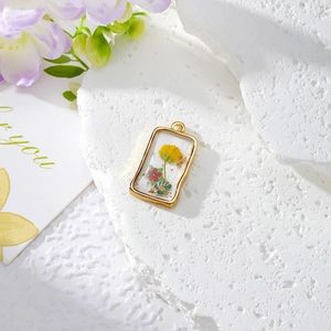 Rectangular resin dried flower pendant with gold metal frame and gold foil flakes
