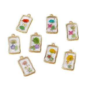 Handmade rectangular resin flower pendants with gold wavy frame and dried floral motifs