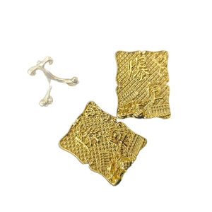 Golden prosperity desk ornament with Chinese engraving and metal stand on white background