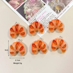 Realistic resin croissant charms for DIY jewelry making in a warm golden orange finish