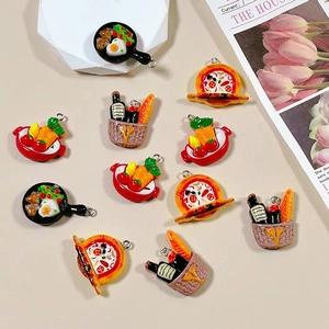 Macro shot of 3D resin miniature food charms with metal rings for DIY jewelry crafting