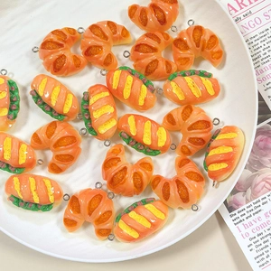 Detailed macro view of realistic resin bread pendants with golden rings for DIY jewelry