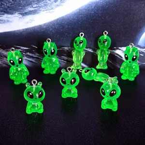 Macro detail of green translucent resin alien pendants with silver metal hooks for DIY