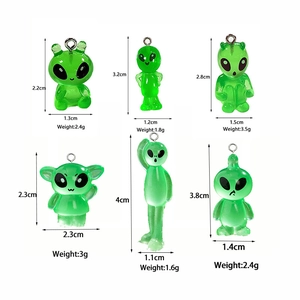 Macro detail of six translucent green resin alien charms for DIY jewelry making