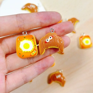 Resin bread food charms featuring fried egg toast and croissant designs for DIY jewelry