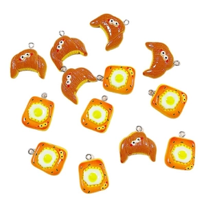 Resin bread and fried egg charms with cartoon faces and silver loops for DIY crafts