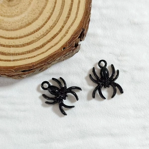 Detail shot of two black spider alloy charms with top hooks for DIY jewelry making