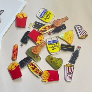 Flat lay of acrylic fast food charms including fries and popcorn for DIY jewelry making