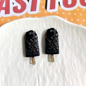 Macro detail of acrylic chocolate ice cream bar charms for DIY jewelry and crafts