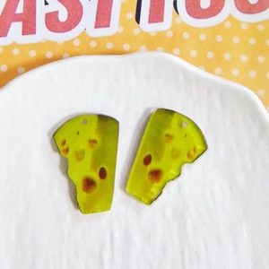 Macro shot of translucent acrylic wedge pendants with brown dots for DIY jewelry making